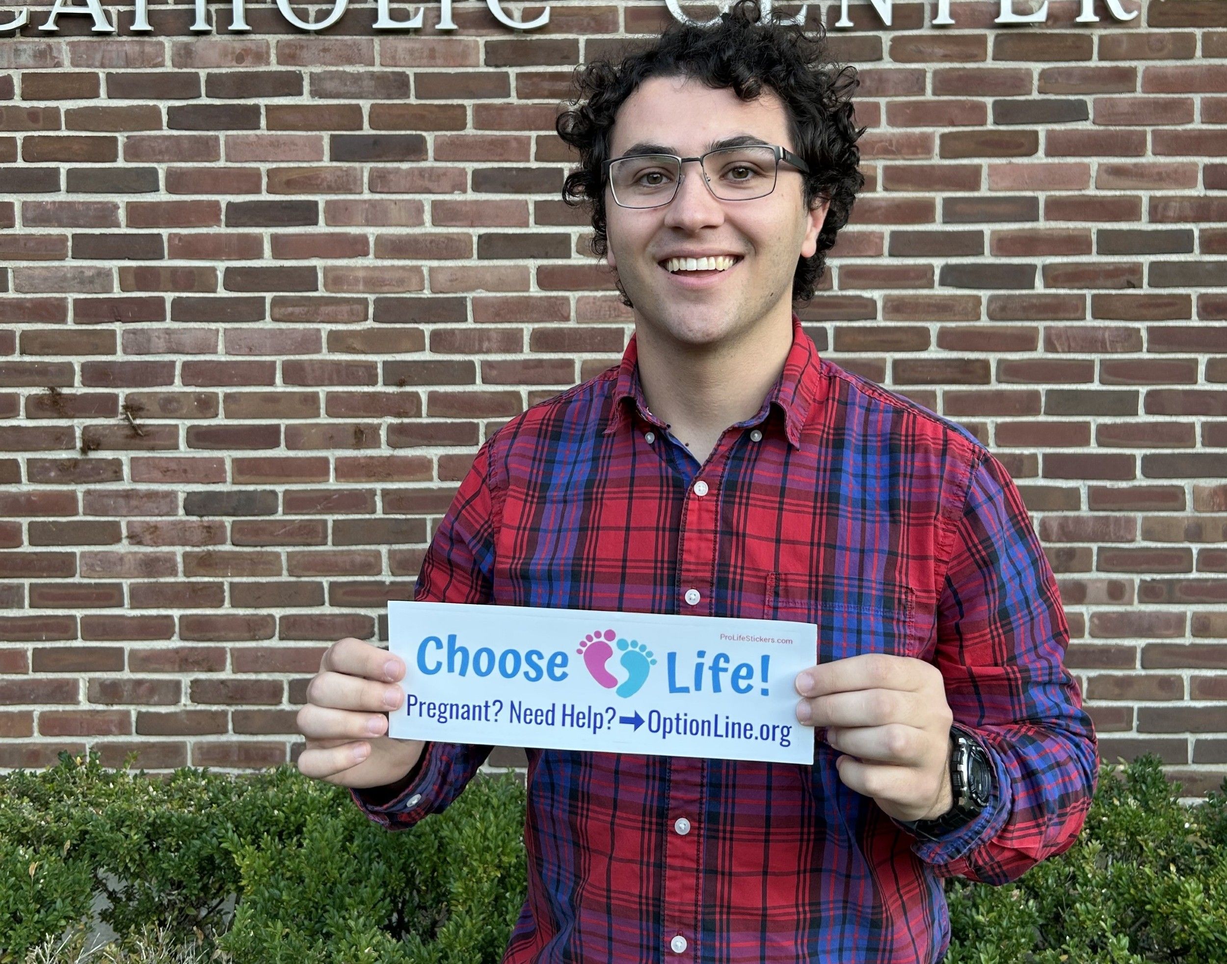 Young man supports pregnancy help with bumper stickers he created