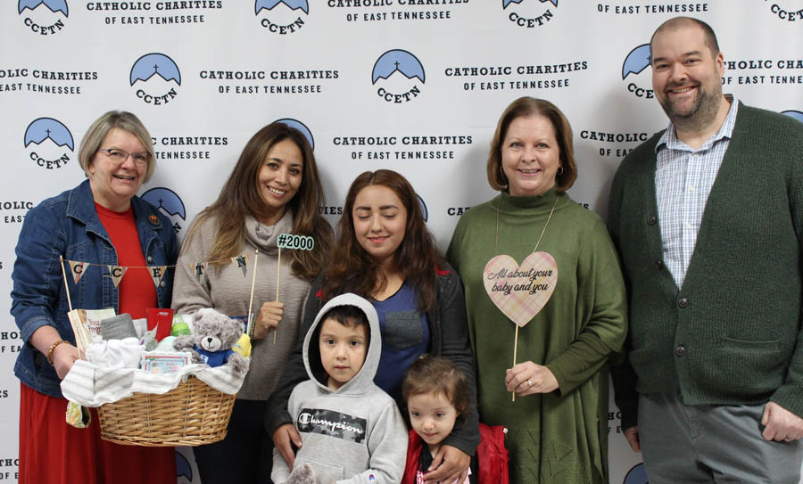 The 2,000th family served by Catholic Charities of East Tennessee's Pregnancy Help Center. Left to right: Ernestine Meiners, Program Coordinator; Ivett Lambert, Hispanic Client Specialist; family #2K - Bessy & children William & Alicxon; Sandi Davidson, Pregnancy Services Program Leader; Paul Ritter Director of Programs 