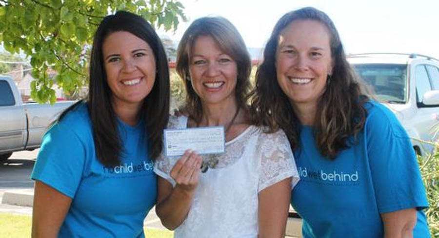 Vera Ulibarri and Carrie Chalverus present a check for $4,500 to Jane Richardson of the Pregnancy Help Center. 
