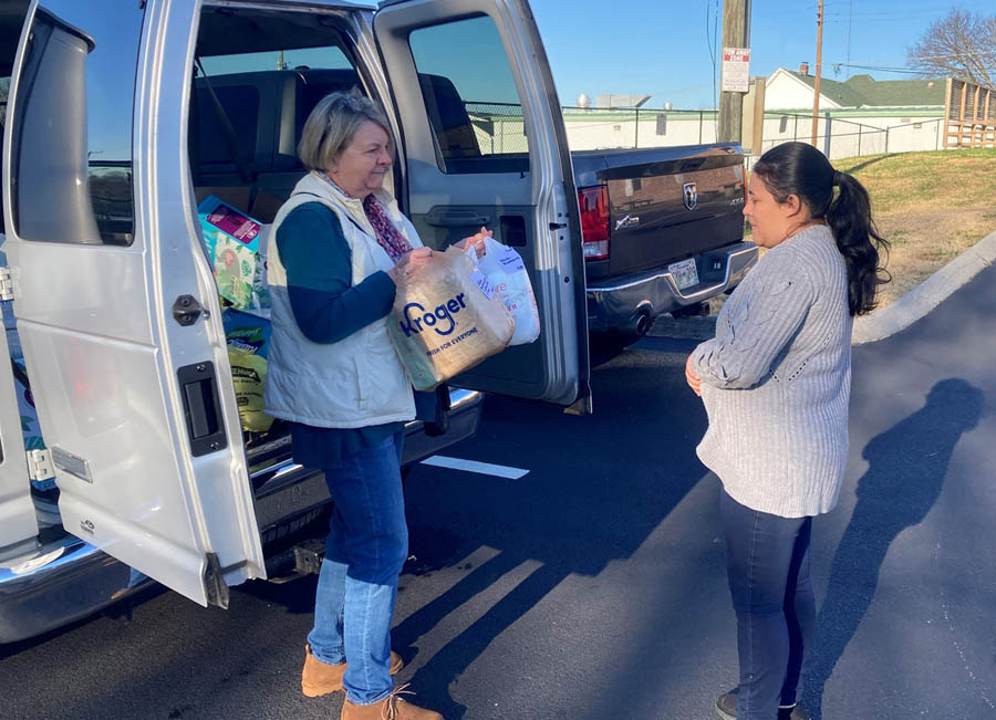 Ernestine Meiners distributes supplies from a van in the parking lot of the Pregnancy Help Center of Knoxville after the center suffered a devastating fire in Nov. 2021.