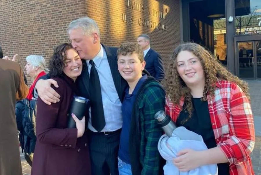 After being acquitted of federal charges by a jury in Philadelphia on Monday, Jan. 30, 2023, Mark Houck embraces and kisses his wife, Ryan-Marie Houck. Also with Houck are his son Mark Houck Jr., 14, and his daughter, Ava Houck, 12.