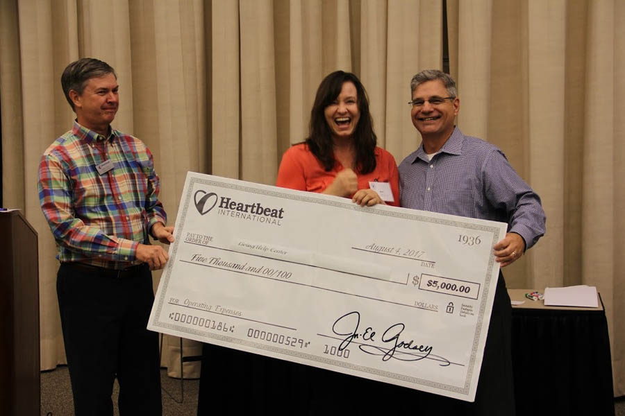 Kirk Walden (left) and Jor-El Godsey present $5,000 check to Mari Wingate for California pregnancy center.